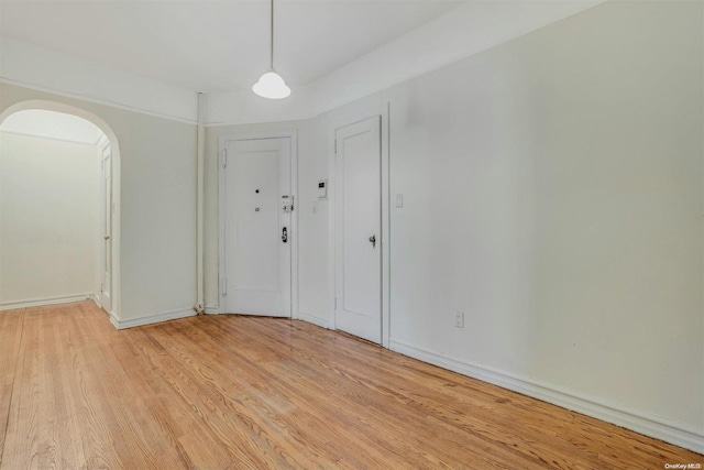 85-10 34th Ave Unit 421, Jackson Heights, NY 11372 - entrance foyer featuring light wood finished floors, arched walkways, and baseboards