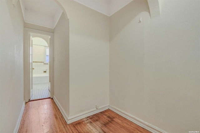 85-10 34th Ave Unit 421, Jackson Heights, NY 11372 - hallway with light wood-style floors, arched walkways, and baseboards