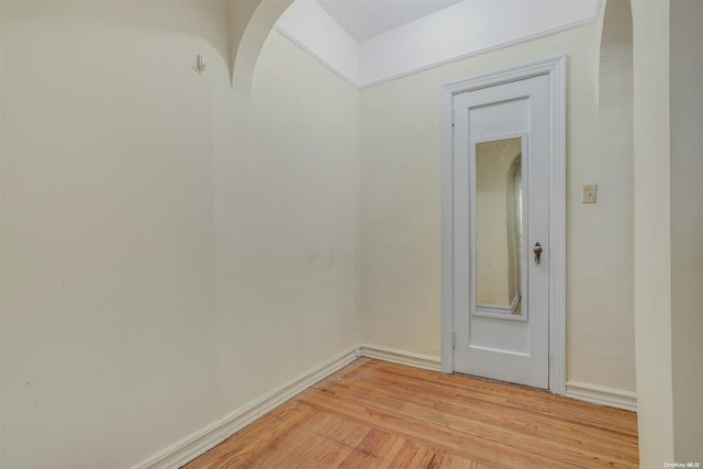 85-10 34th Ave Unit 421, Jackson Heights, NY 11372 - unfurnished room with light wood-type flooring, arched walkways, and baseboards