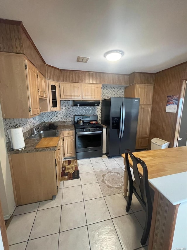 kitchen with sink, stainless steel range, tasteful backsplash, light tile patterned flooring, and black fridge with ice dispenser