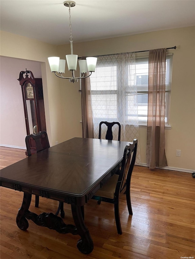 dining room with a notable chandelier and light hardwood / wood-style flooring