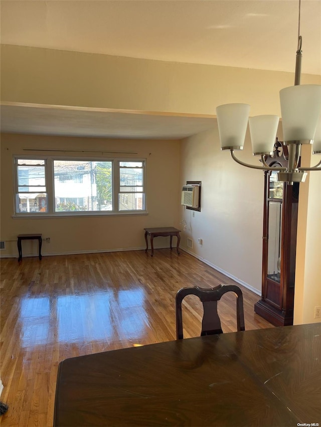 unfurnished dining area with hardwood / wood-style flooring, plenty of natural light, and a notable chandelier