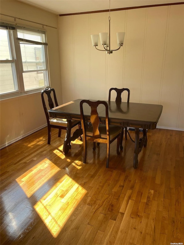 dining space featuring hardwood / wood-style flooring and a notable chandelier