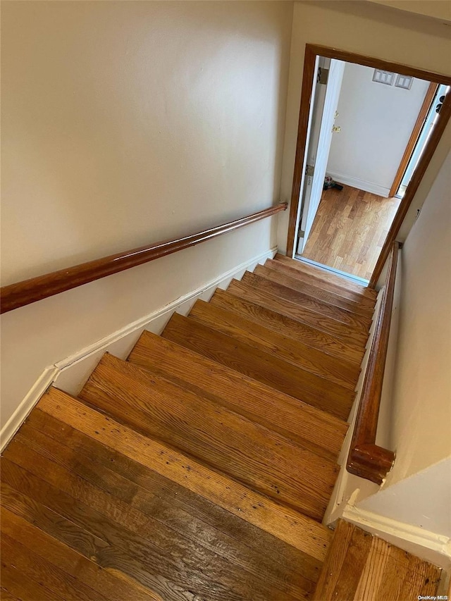 stairway featuring hardwood / wood-style floors