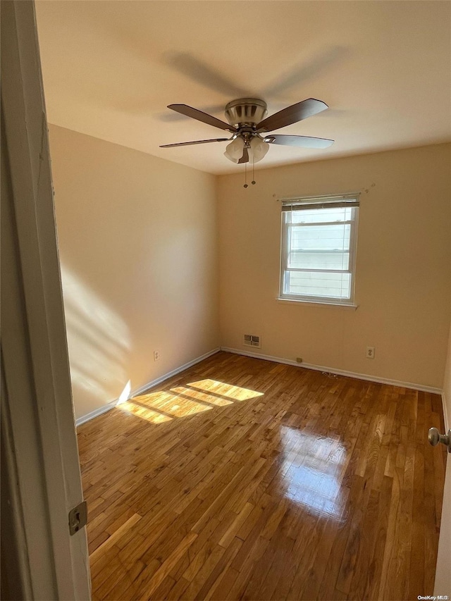 spare room featuring ceiling fan and wood-type flooring