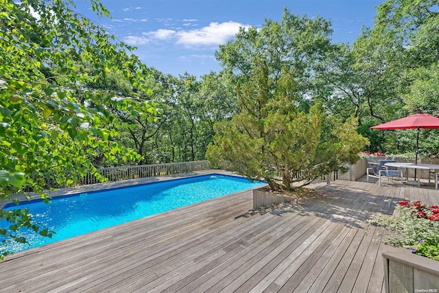 view of swimming pool featuring a wooden deck