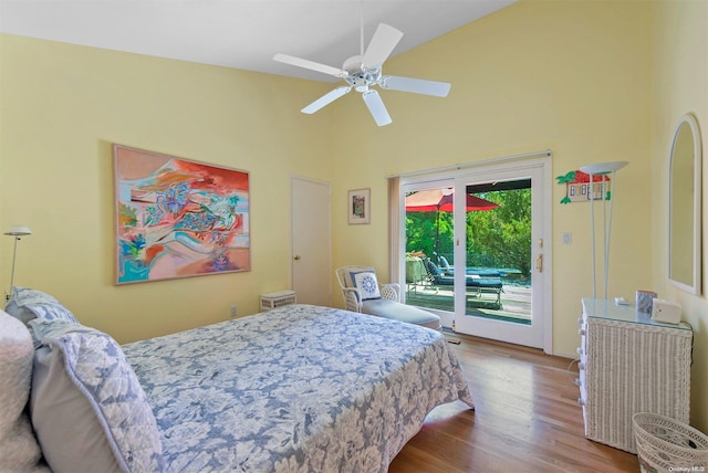 bedroom with access to exterior, ceiling fan, wood-type flooring, and lofted ceiling