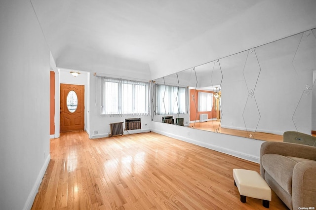 living room featuring hardwood / wood-style floors, radiator heating unit, and heating unit