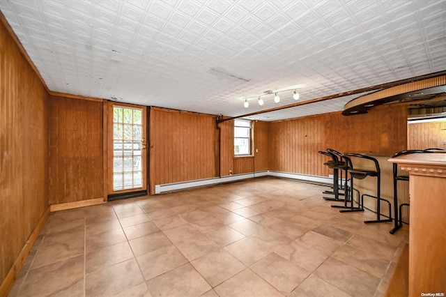 empty room with wooden walls and rail lighting