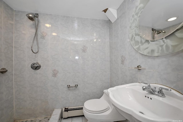 bathroom with sink, tile patterned floors, baseboard heating, and tile walls