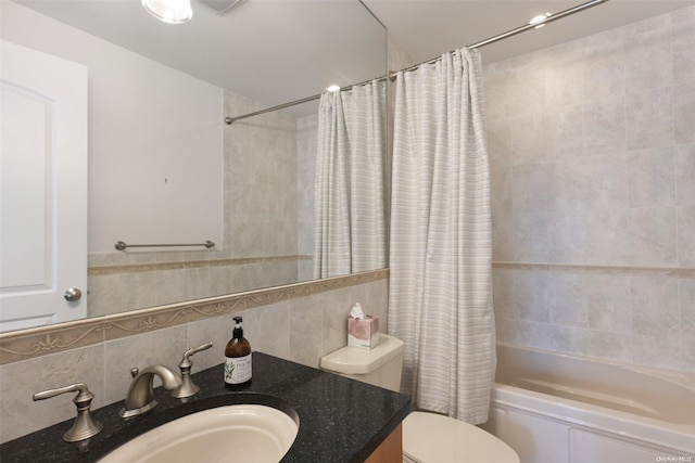 full bathroom with shower / tub combo, backsplash, vanity, tile walls, and toilet