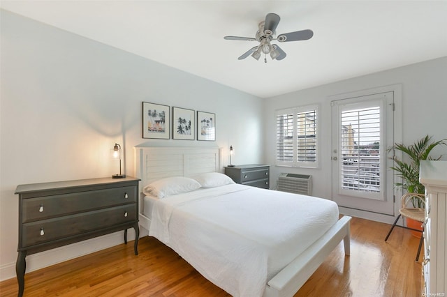 bedroom with access to outside, ceiling fan, light hardwood / wood-style flooring, and an AC wall unit