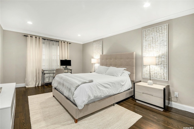 bedroom with dark hardwood / wood-style floors and crown molding