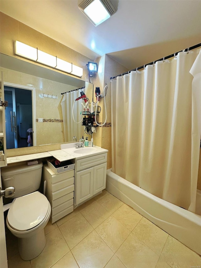 full bathroom with tile patterned flooring, vanity, tile walls, toilet, and shower / tub combo with curtain