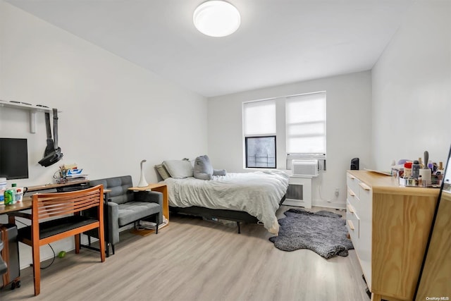 bedroom featuring light wood-type flooring and cooling unit