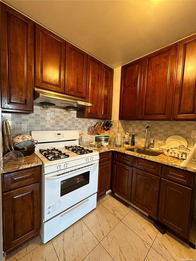 136-21 Latimer Pl Unit 5Hp16, Flushing, NY 11354 - kitchen with gas range gas stove, under cabinet range hood, a sink, light marble finish flooring, and tasteful backsplash