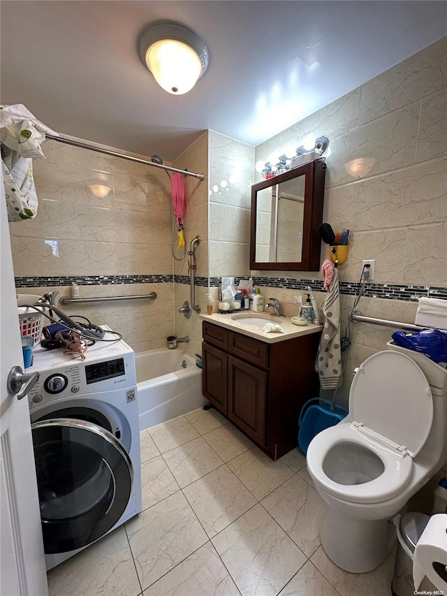 full bathroom with tiled shower / bath, tile walls, and washer / dryer