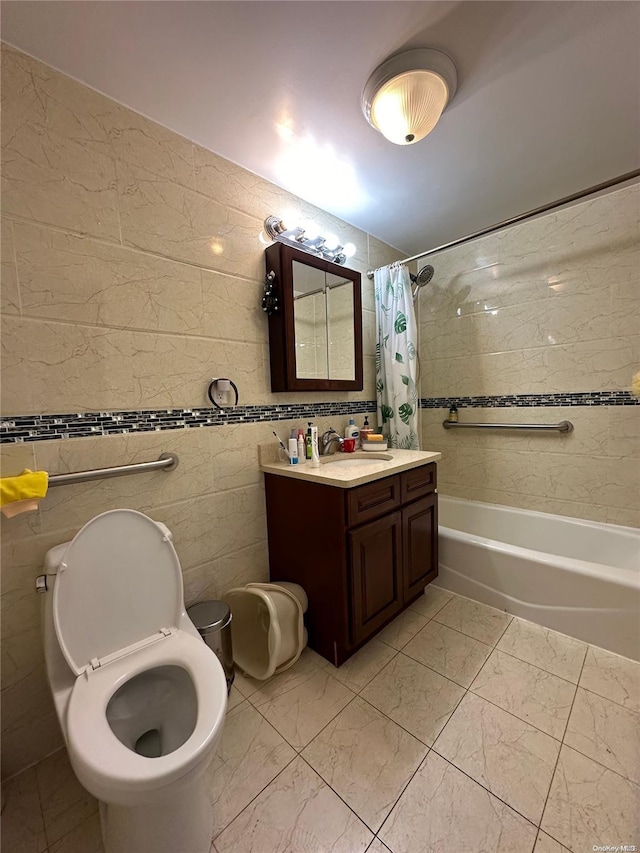 full bathroom featuring vanity, toilet, shower / bath combo with shower curtain, and tile walls