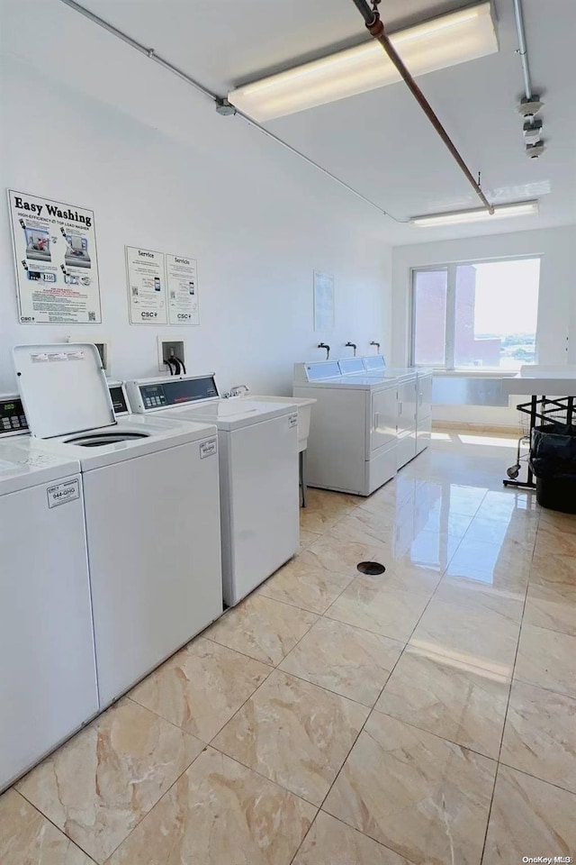 clothes washing area featuring separate washer and dryer