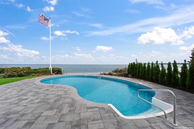 view of swimming pool with a water view