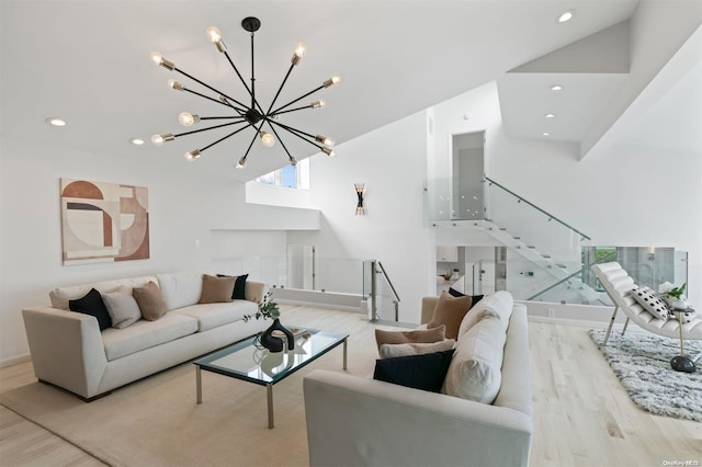 living room with light hardwood / wood-style floors and a notable chandelier