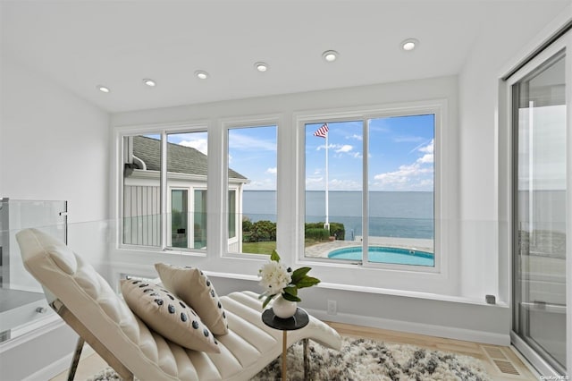 interior space featuring light wood-type flooring and a water view