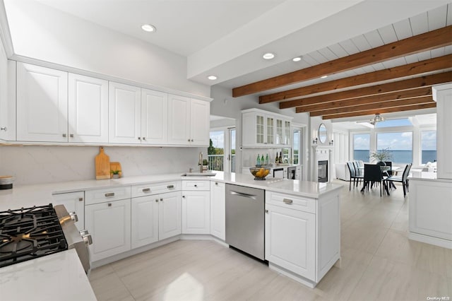 kitchen with white cabinetry, a wealth of natural light, a water view, and stainless steel appliances