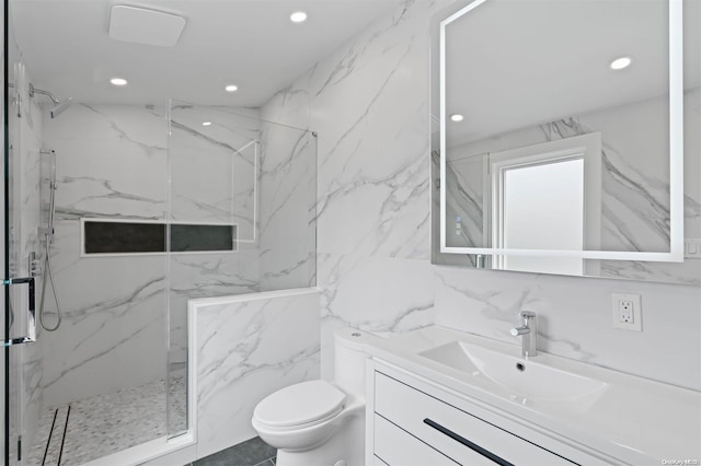 bathroom featuring vanity, toilet, tile walls, and walk in shower