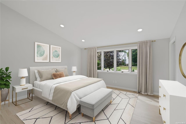 bedroom with light hardwood / wood-style flooring and vaulted ceiling