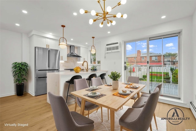 dining space featuring a baseboard heating unit, light hardwood / wood-style floors, a wall unit AC, and a notable chandelier