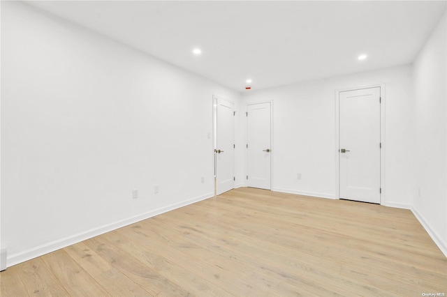 empty room with light hardwood / wood-style floors