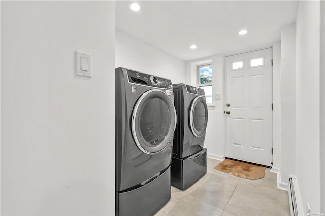 washroom featuring separate washer and dryer, a baseboard radiator, and light tile patterned flooring