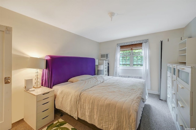 bedroom with carpet flooring and a wall mounted air conditioner