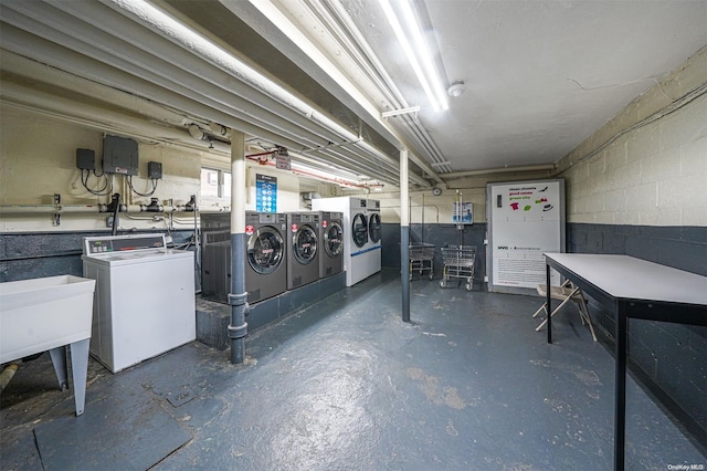 basement with sink and washing machine and clothes dryer