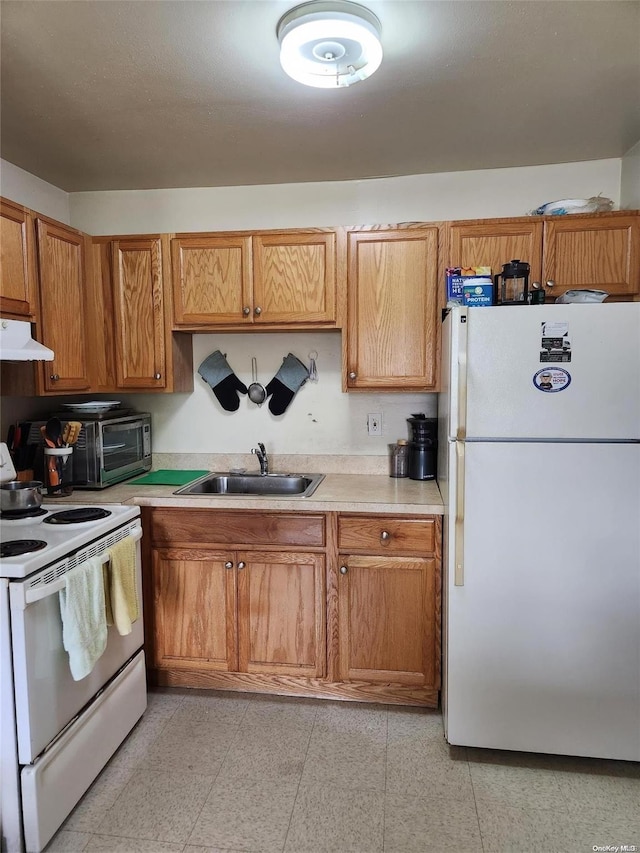 kitchen featuring white appliances and sink