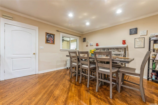 dining room featuring crown molding and dark hardwood / wood-style flooring