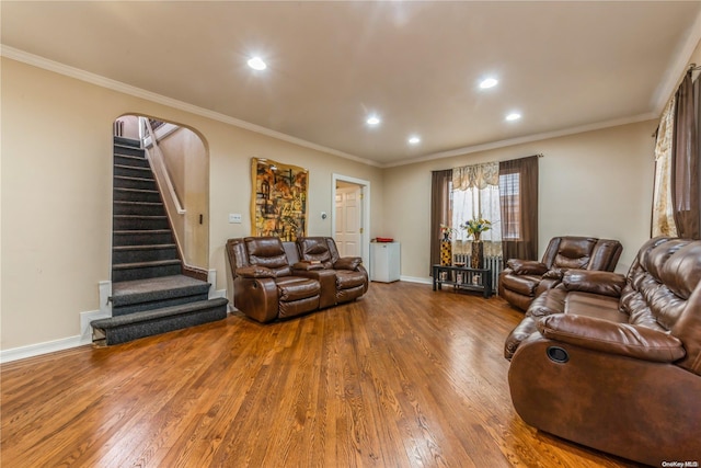 living room featuring ornamental molding, a notable chandelier, and hardwood / wood-style flooring