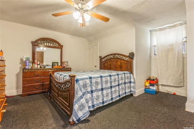 bedroom with dark colored carpet and ceiling fan