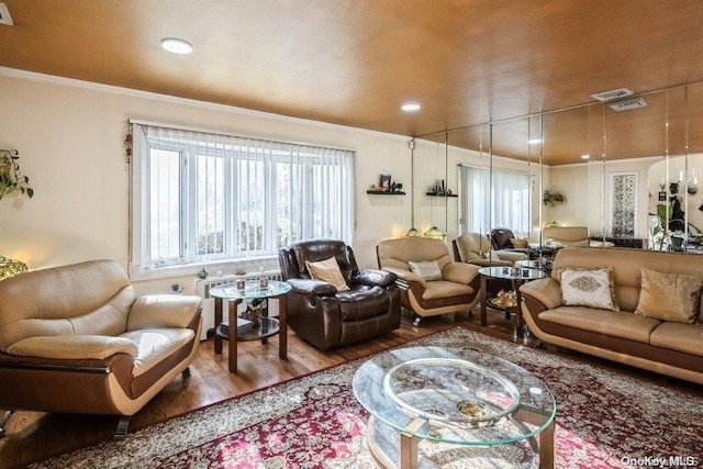 living room with ornamental molding and hardwood / wood-style flooring