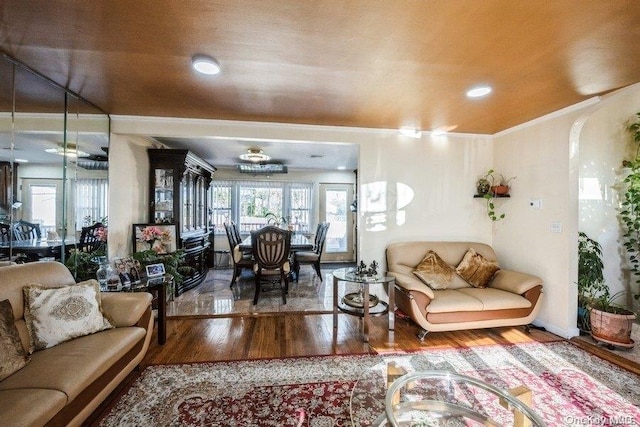 living room with crown molding and hardwood / wood-style floors