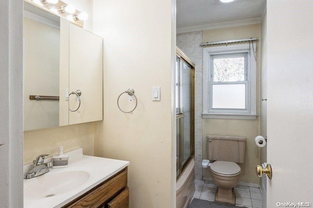 full bathroom featuring tile patterned flooring, combined bath / shower with glass door, toilet, vanity, and ornamental molding