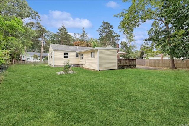 rear view of property featuring a lawn