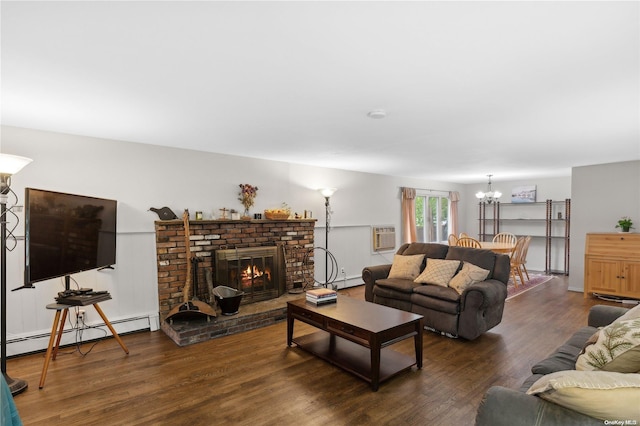 living room featuring a fireplace, dark hardwood / wood-style floors, a baseboard heating unit, and a notable chandelier