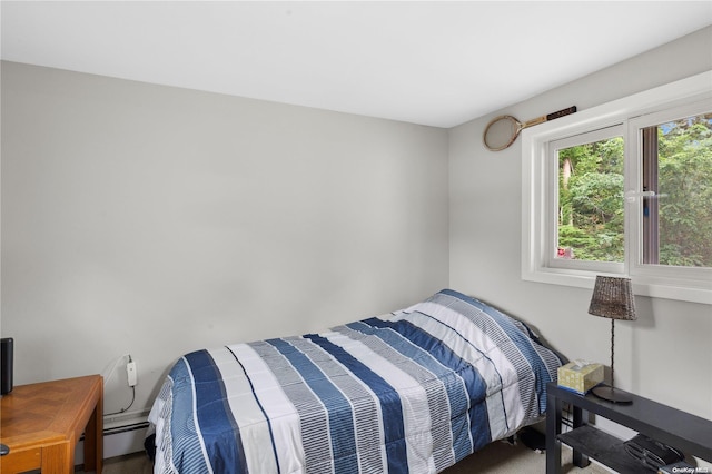 carpeted bedroom featuring a baseboard heating unit