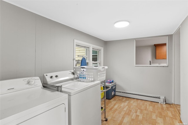 laundry area with independent washer and dryer, wooden walls, light hardwood / wood-style floors, and a baseboard heating unit