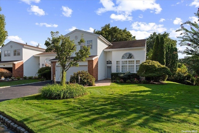 view of front property featuring a garage and a front lawn