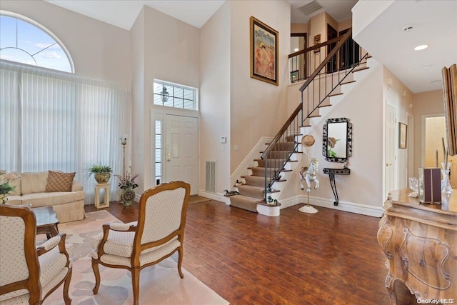 foyer with hardwood / wood-style flooring and a high ceiling