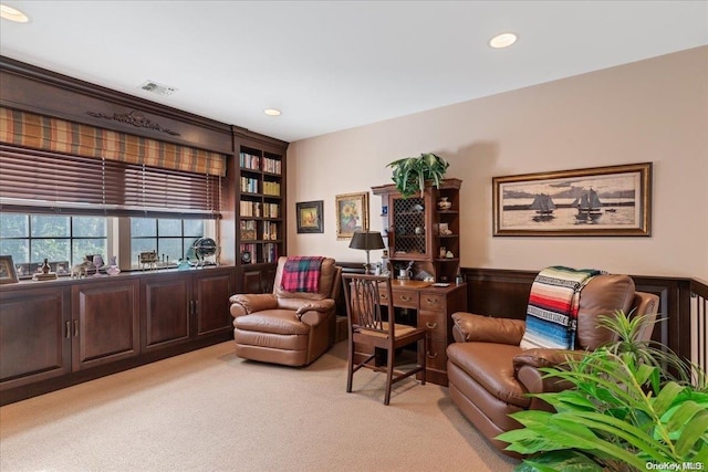 living area featuring light colored carpet and wooden walls