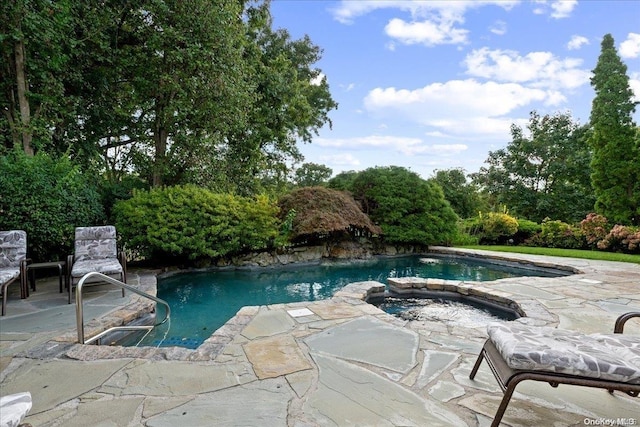 view of swimming pool with an in ground hot tub and a patio