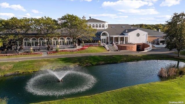 back of property featuring a water view